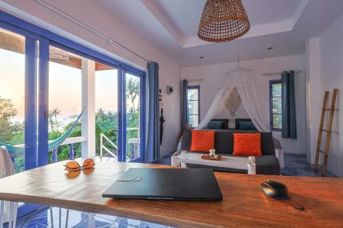 a laptop on a table in a room with a bed at Archie Village in Hinkong