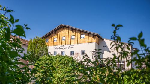 a building with a wooden roof on top of it at Hotel-Restaurant Früchtl in Zandt