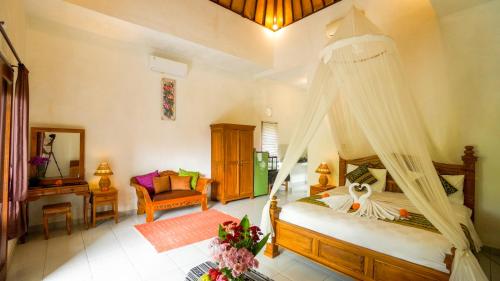 a bedroom with a bed with a mosquito net at The Oding House in Ubud