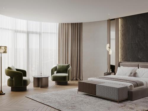 a bedroom with a large bed and two chairs at Donatello Premium Almaty in Almaty