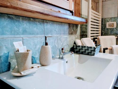 a bathroom with a white sink and a blue wall at Agriturismo PALMERI in Avola