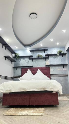 a bedroom with a large bed with a wooden wall at "Augustina" apartment in Topliţa