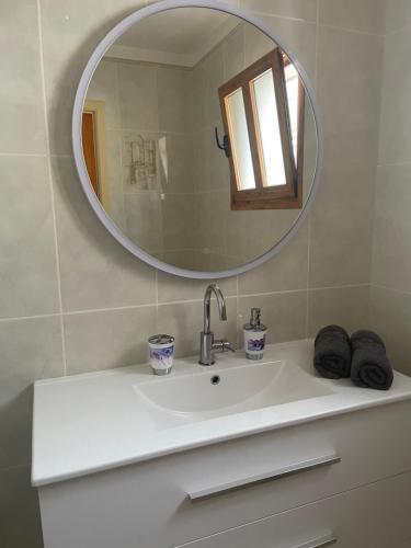 a bathroom with a sink and a mirror at Apartmán Vlasta in Arona