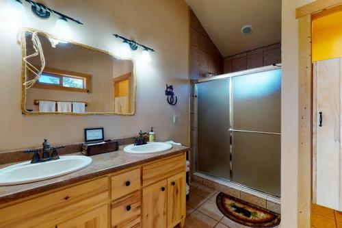a bathroom with two sinks and a shower at Rivercrest in South Fork