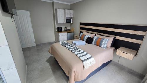 a bedroom with a large bed with a wooden headboard at Waverley Rest in Bloemfontein