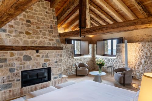 a room with a stone wall and a fireplace at Le Torri di Credazzo in Farra di Soligo