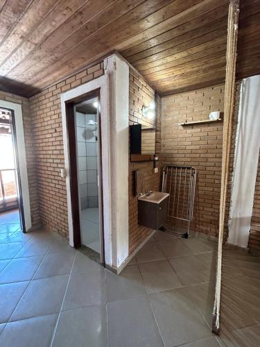a bathroom with a sink and a mirror at Flats na praia de Trindade Paraty flats nazar in Paraty
