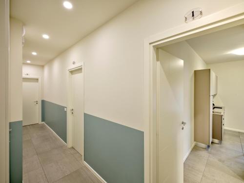 an empty hallway with white walls and doors at Pegaso Civico2 in Garda