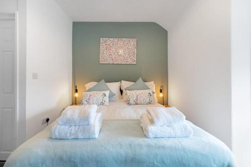 a bedroom with a large bed with towels on it at NEW! 3 Bedroom Home in Sunderland by Stay With Us, Perfect for Families & Contractors, FREE WiFi!! in Ryhope