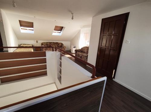 a room with a staircase and a room with a door at Csengi Apartman in Balatonszárszó