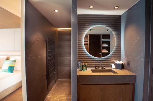 a bathroom with a sink and a mirror at Fahrenheit Seven Les Menuires in Les Menuires