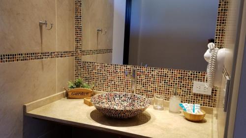 a bathroom with a sink with a bowl on it at Aires Serranos - Suites in La Cumbrecita