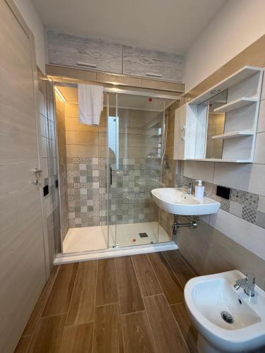 a bathroom with a shower and a sink and a toilet at La Rosa dei Venti in SantʼAntìoco