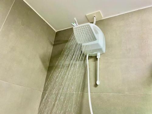 a shower with water coming out of a wall at Maxplaza Residential 1209 in Canoas