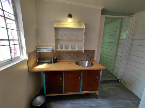 a kitchen with a sink and a window at Uncle Charlie in Kroonstad