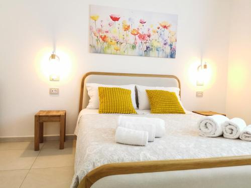 a bedroom with a bed with towels on it at Domus Soli in Teulada