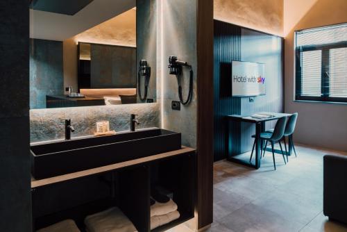 a bathroom with a sink and a table with a bed at Hotel PALAZZO PEPE & JACUZZI in Naples