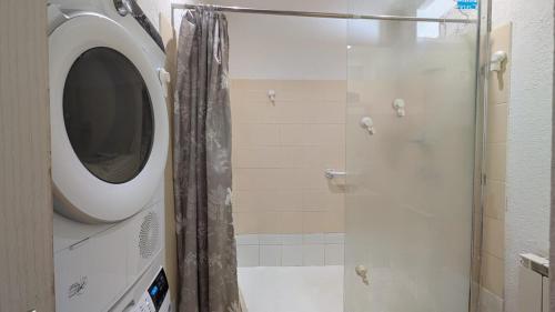 a bathroom with a shower with a shower curtain at Le jardin Provençal in Saint-Saturnin-lès-Avignon