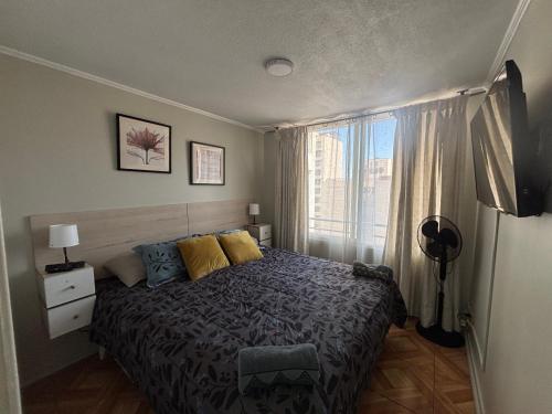 a bedroom with a bed and a window at Inversiones Inmobiliarias AYD in Santiago