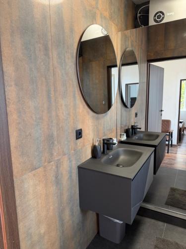 a bathroom with two sinks and a mirror at Old Stone House 2 in Mlini