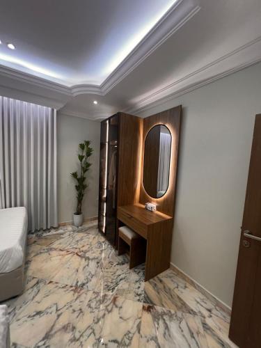 a hotel room with a bed and a mirror at luxury rooftop apartment in Jeddah