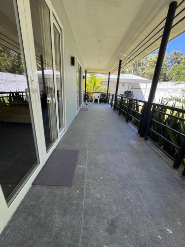 a walkway leading to a building with glass doors at Casa G in Bacong