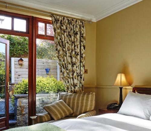 a hotel room with a bed and a window at Wild Honey Inn in Lisdoonvarna