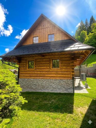 a log cabin with a gambrel roof at Chata Sipkova II in Terchová