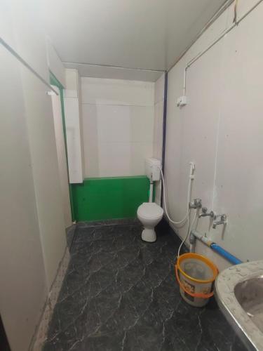 a small bathroom with a toilet and a sink at Linga Wooden Room Second floor in Kanchipuram