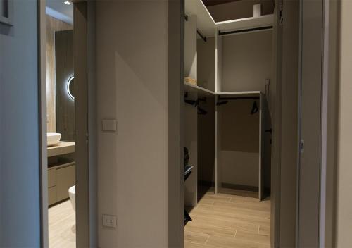 a hallway leading to a bathroom with a sink at Lanza Luxury Home in Verona