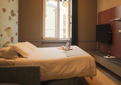 a bedroom with a large bed with a window at Lanza Luxury Home in Verona