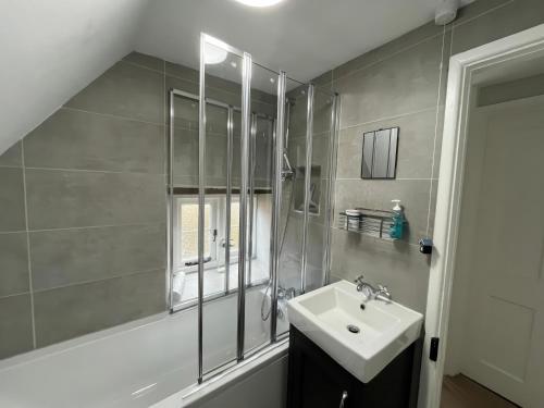 a bathroom with a sink and a shower at Little Ivy in West Lulworth