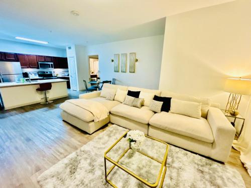 a living room with a white couch and a table at Cozy & Chic Frisco Scape in Frisco