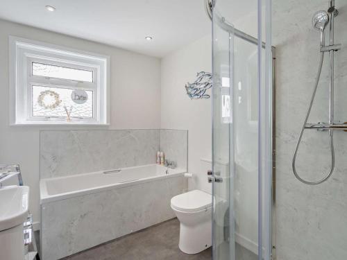 a bathroom with a tub and a toilet and a sink at 3 Bed in Dumfries oc-96066 in Dumfries