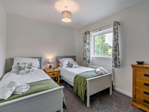 a bedroom with two beds and a window at 3 Bed in Dumfries oc-96066 in Dumfries