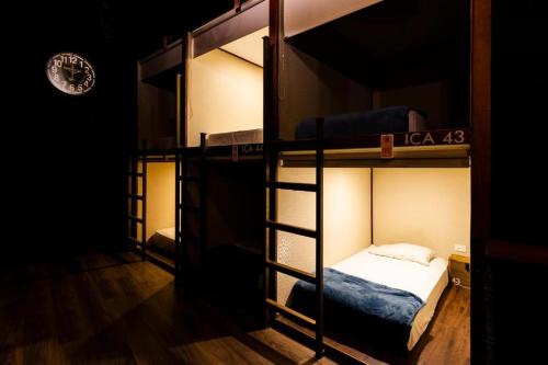 a room with three bunk beds in a room at The Clock Hostel & Suites in Cartagena de Indias