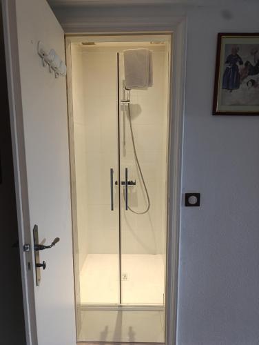 a shower with a glass door in a bathroom at Trégouët 8 - Chambre 2 in Saint-Nazaire