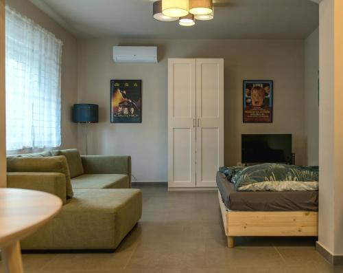 a living room with a couch and a table at Emma Casa Apartmant FREE Private Parking with EV supply availability in Budapest