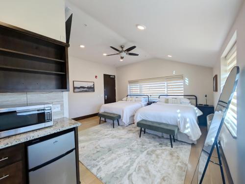 a bedroom with two beds and a flat screen tv at Iron Springs Luxury Lodge & Spa in Cedar City