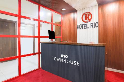 an office with a table and arothride sign on the wall at Townhouse RIO in Hyderabad