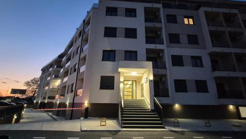 a building with a staircase leading to a door at Silver Marina Residence in Veliko Gradište