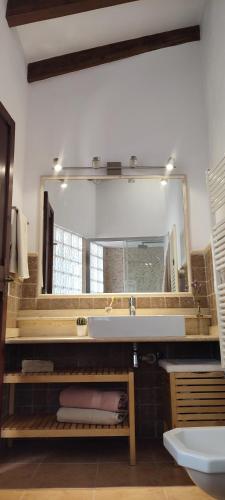 a bathroom with a sink and a large mirror at Casa Alacantí in Pollença