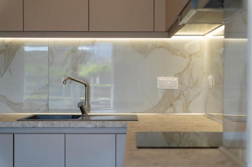 a kitchen with a sink and a counter top at ElGio Maisonette Nikiti in Nikiti