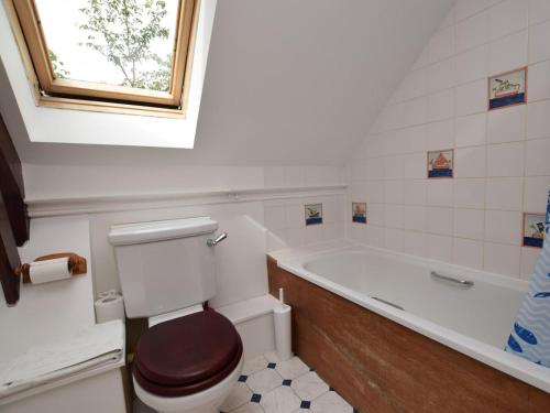 a bathroom with a toilet and a bath tub at 2 Bed in Biggar oc-ca366 in Biggar