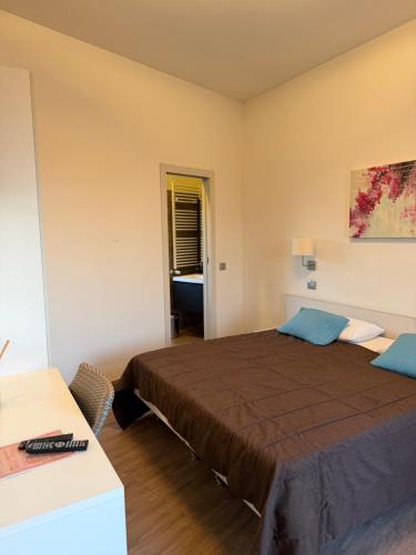 a bedroom with a large bed and a desk at Casa Makeda in Rosate