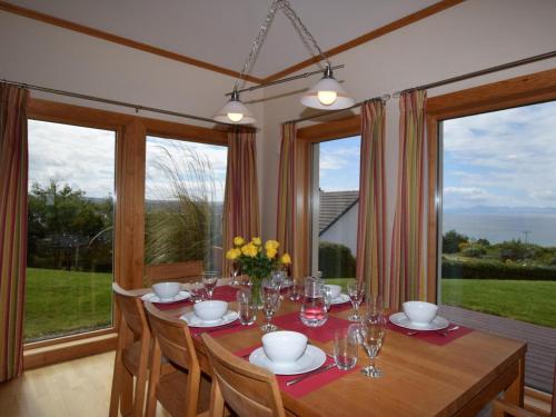 a dining room with a table and some windows at 4 Bed in Gairloch oc-29010 in Gairloch