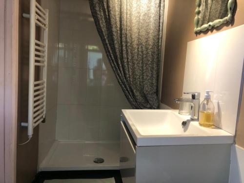 a bathroom with a sink and a shower at The Dairy stylish chalet for 2 opp the beach 1 minute walk in Whitstable