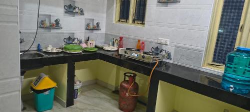a kitchen with a sink and a counter top with at Close2heaven 3 bedroom privacy Home with a hall and a paid kitchen in Kodaikānāl