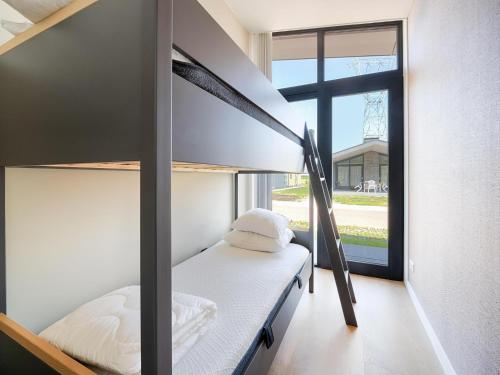 a bedroom with two bunk beds and a window at Leiden in Oud-Ade