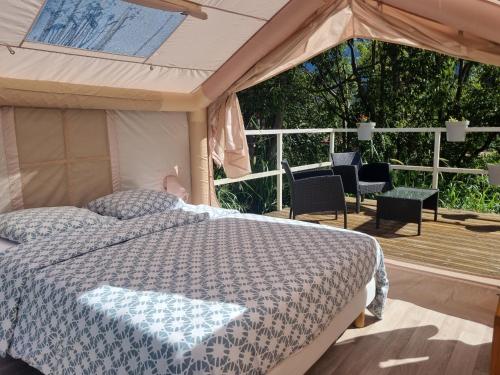 a bedroom with a bed in a tent at La tente de Cléa in Salazie